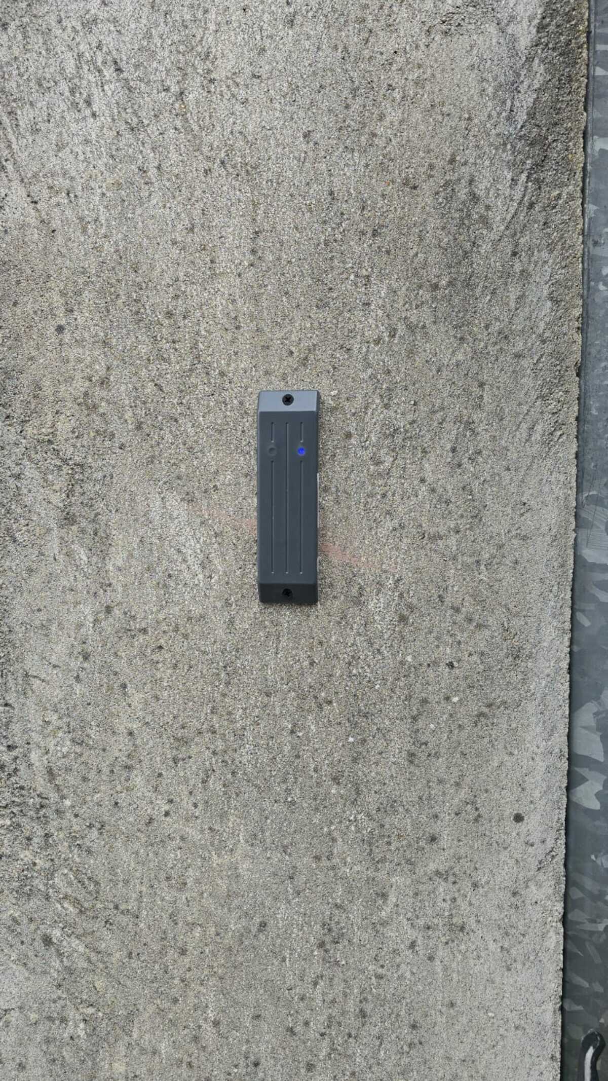 Installation Caméra Sécurité et Maison Intelligente Technicien installant une caméra de sécurité dôme au plafond tout en gérant le système de maison intelligente avec un smartphone affichant un code de verrouillage.